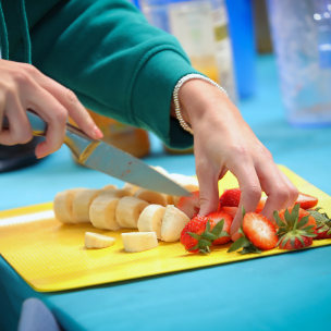 Person cutting fruits